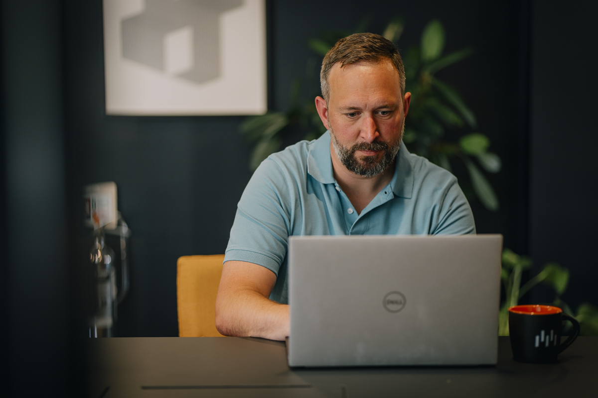 Sam Watts, MetaMetrics Director looking at a laptop
